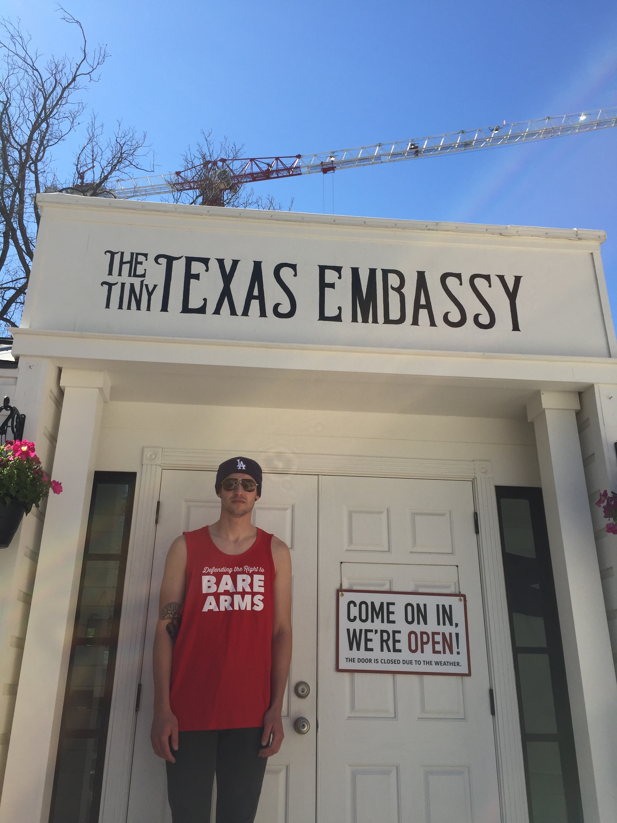 Jake Beam taking a picture at the The Tiny Texas Embassy while wearing his Harris Media "Defending the right to bare arms" shirt. 